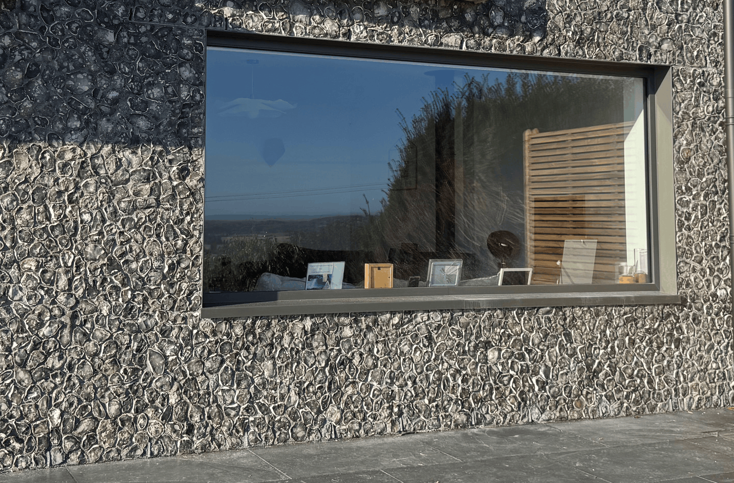 These aluminium cheeks created  a crisp corner detail on this knapped flint work extension in Sussex.